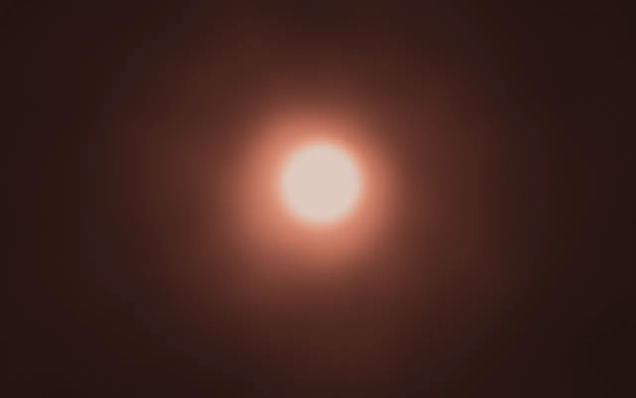 A single glowing orb of cream light with a soft peach halo, centered on a dark brown background.