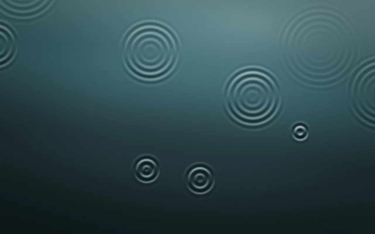 Concentric rings spread across dark teal water, some large and faint, others small and sharp.